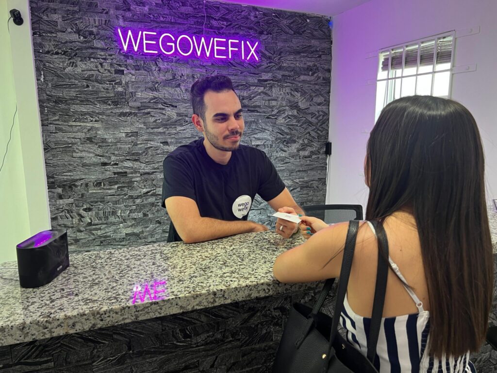 a man sitting at a counter with a woman in front of him