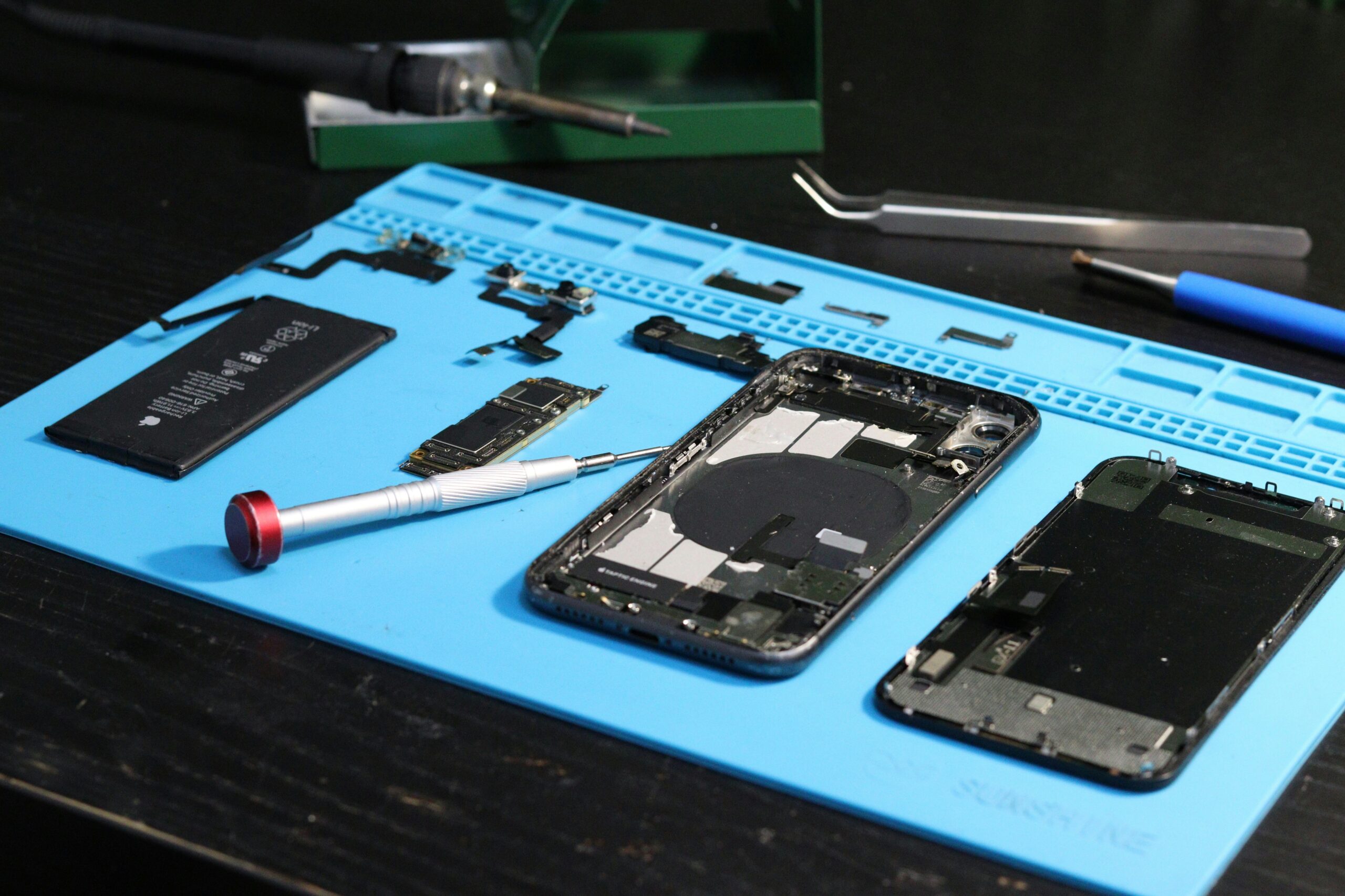 Disassembled iPhone and precision repair tools